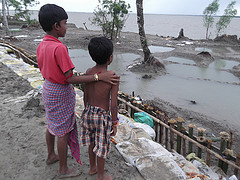 Children looking at flooded land