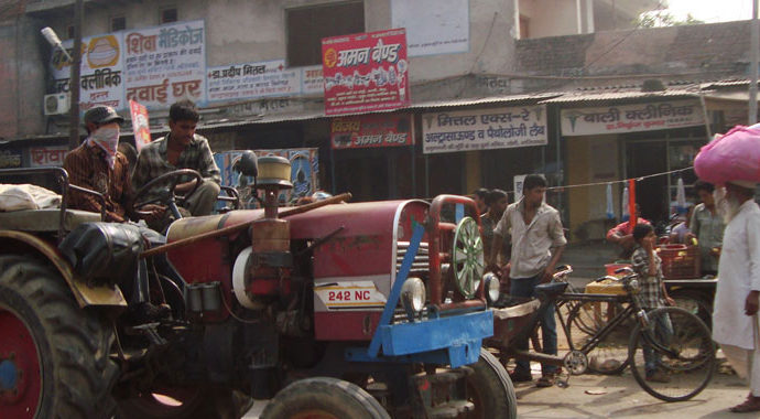 Farmers driving through the village of Karhera in India