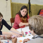 group discussion around a table with colourful graphical objects