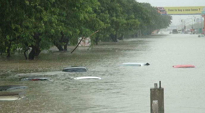 Flooded avenue in Mumbai with only the tops of cars showing above the water