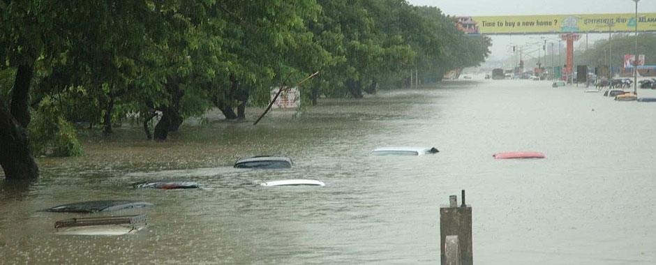 Flooded avenue in Mumbai with only the tops of cars showing above the water