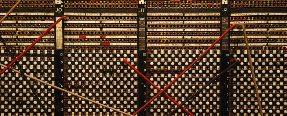 Large old telephone switchboard with connecting wires