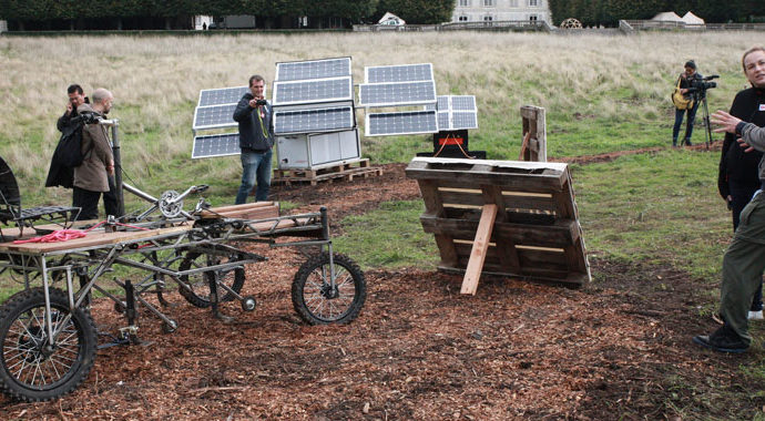 Outdoor exhibition with prototype pedal tractor and solar panels