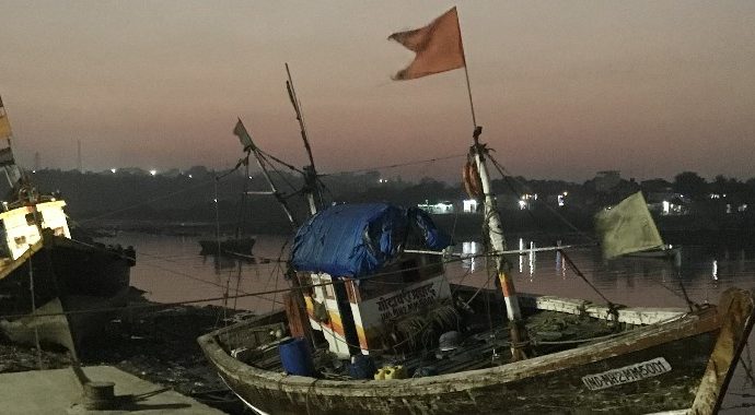 small fishing boats with flags waving in the breeze