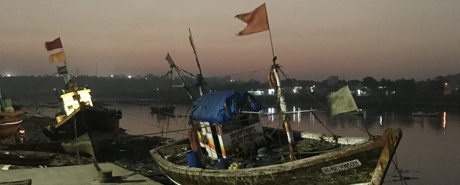 small fishing boats with flags waving in the breeze