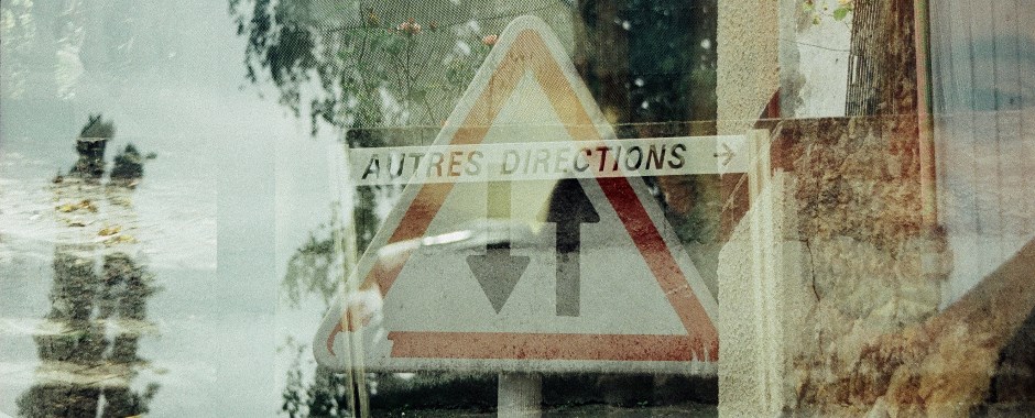 Triple exposure photograph with road sign reading 'Autres Directions'