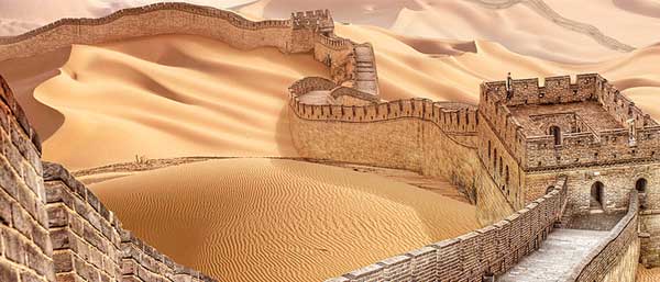 Great wall of China surrounded by sand.