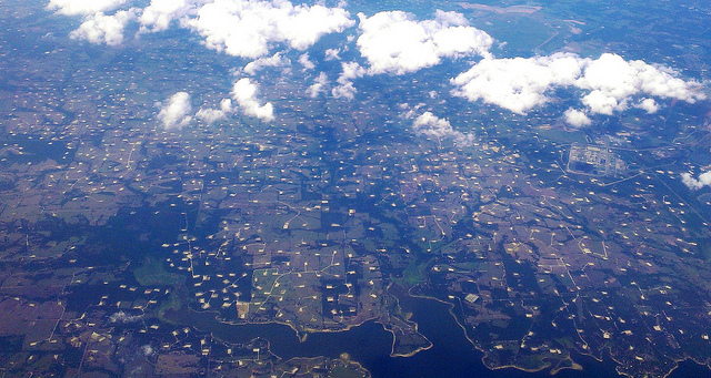 Aerial view of small roads with small pits or lakes taken from a plane. 