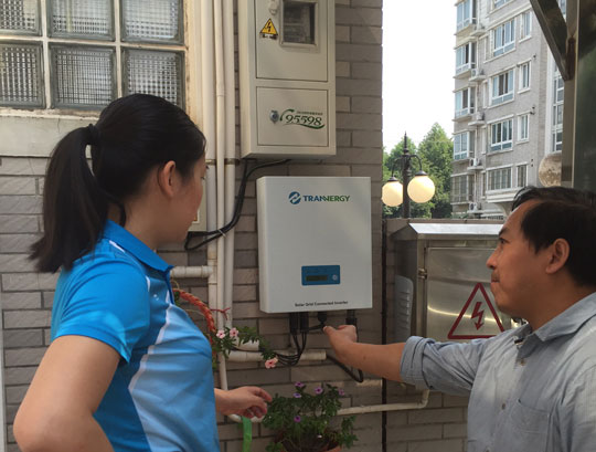 Chinese woman and man examine an energy unit